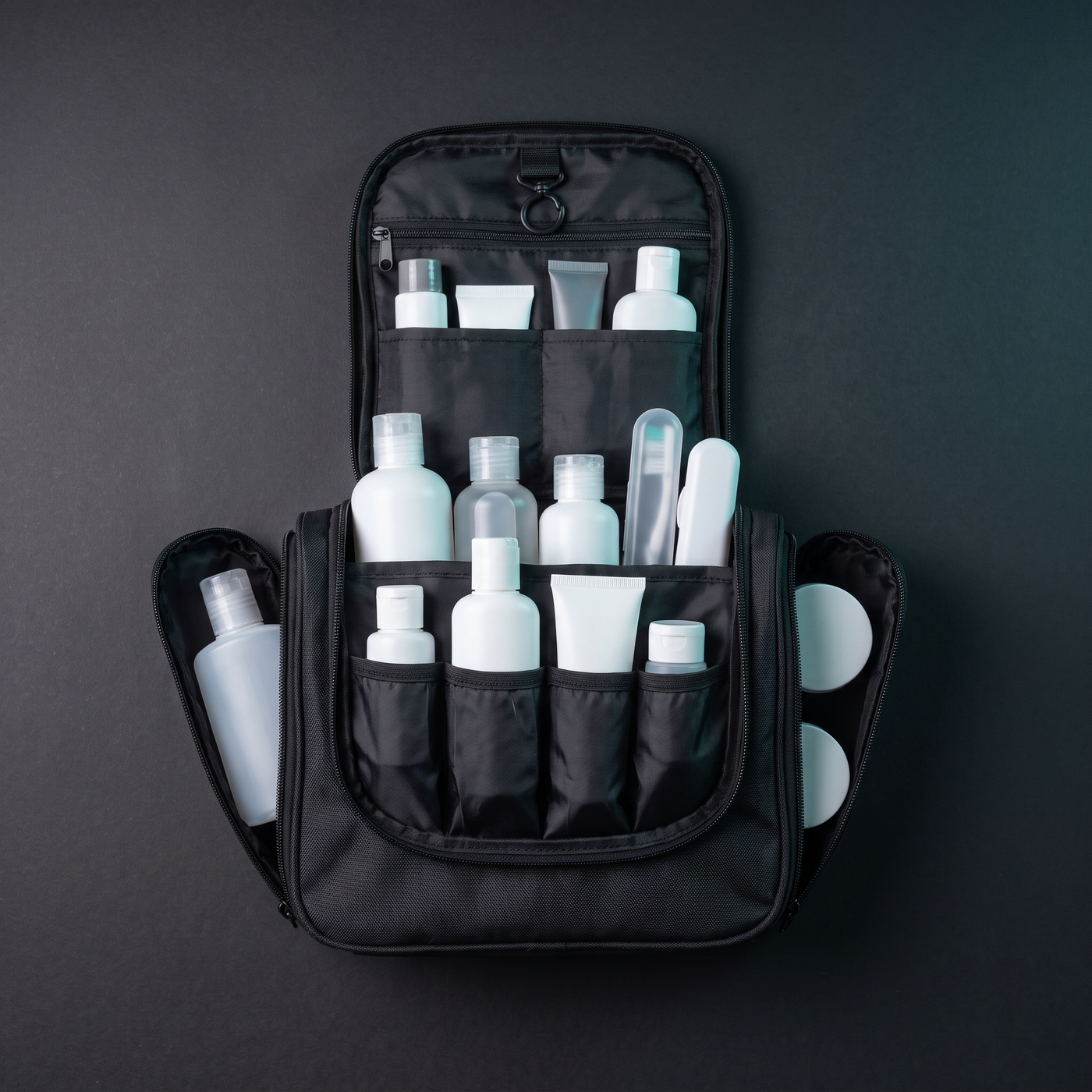 Trousse de toilette Voyra ouverte à plat avec produits de voyage